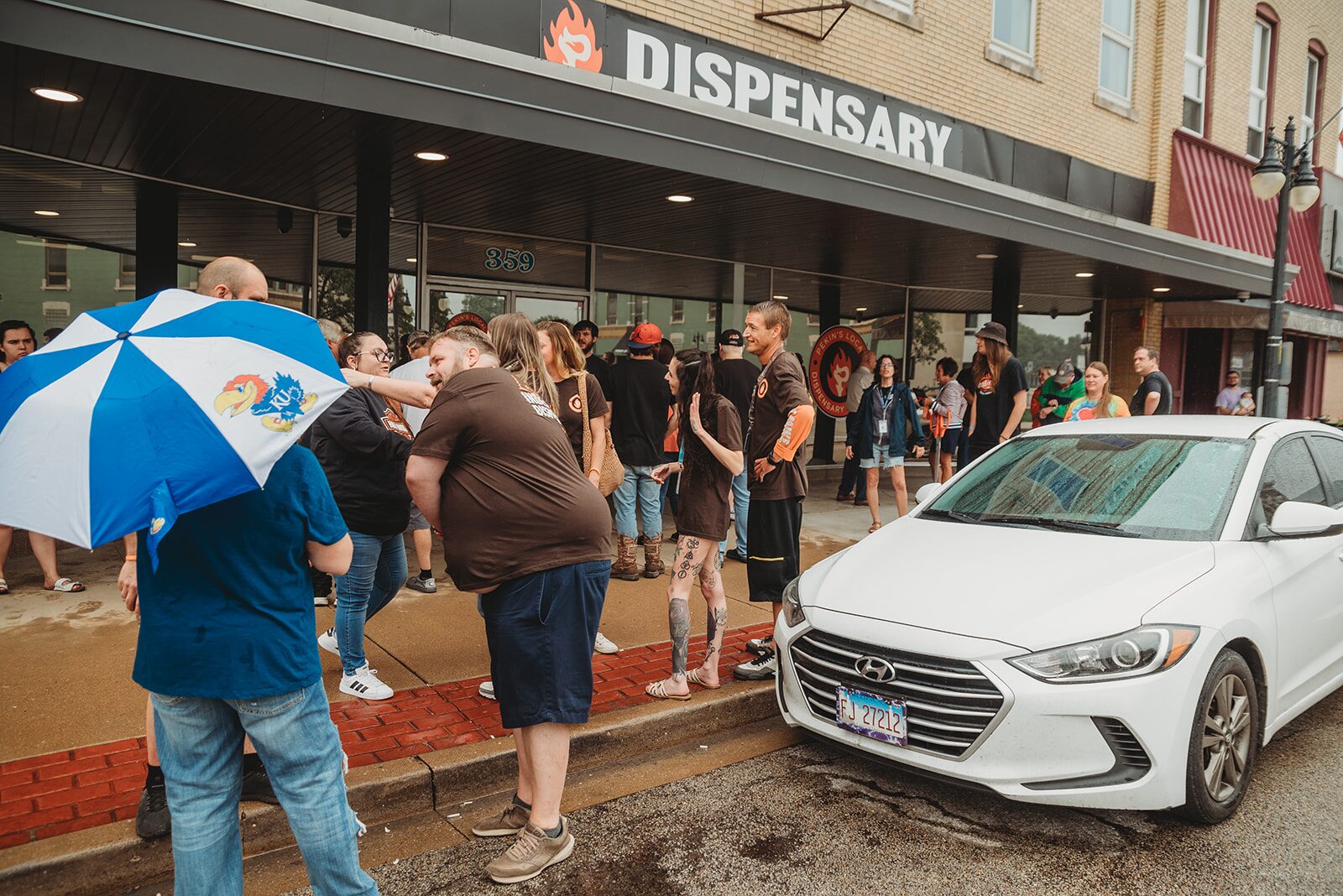 People gathered outside Pekin's Local Dispensary & Supply at 359 Court St in downtown Pekin, Illinois on opening day