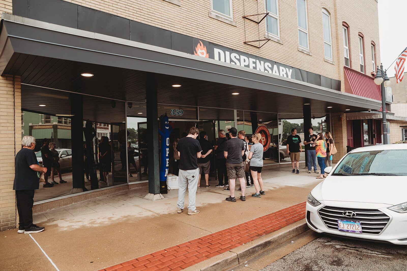 Crowd gathered outside Pekin's Local Dispensary storefront on Court St in Pekin, IL on opening day