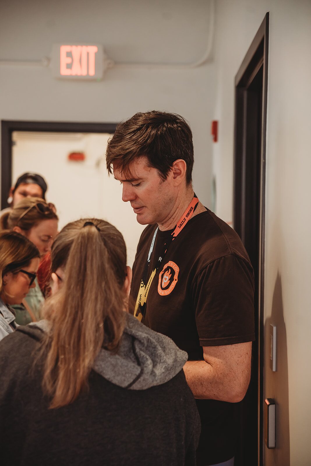 A Pekin's Local Dispensary team member greeting guests at the entrance in Pekin, IL